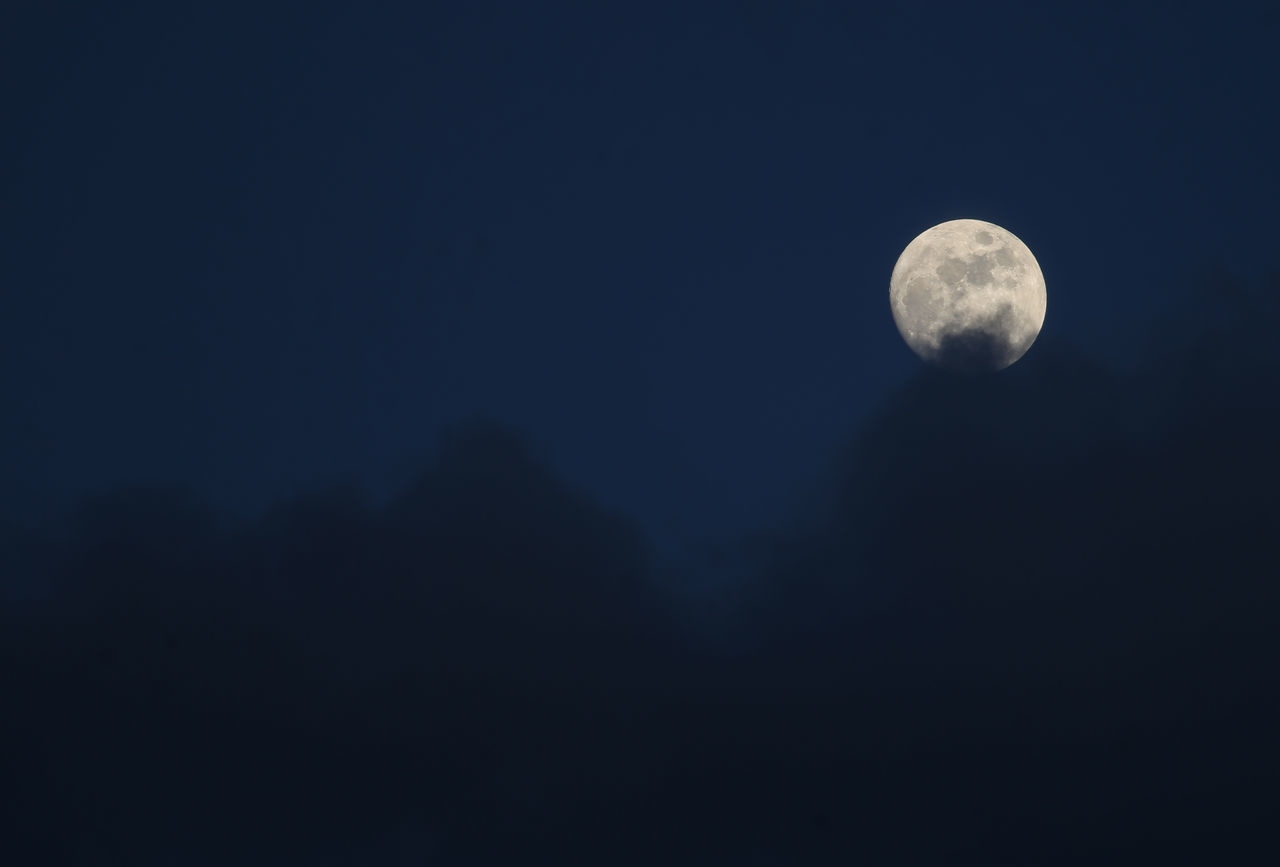 LOW ANGLE VIEW OF MOON IN SKY AT NIGHT