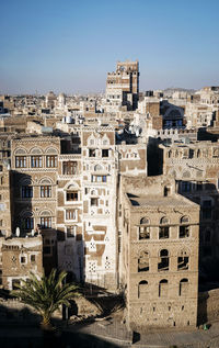Old buildings in city against sky