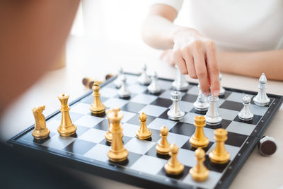 Midsection of woman playing with chess