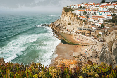 Aerial view of town on mountain by sea