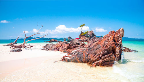 Scenic view of beach against blue sky