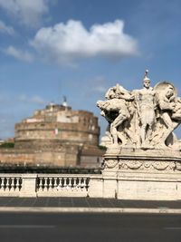 Statue of historical building against cloudy sky