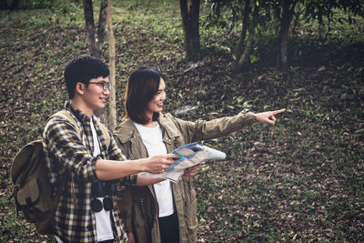 Young man using mobile phone in forest