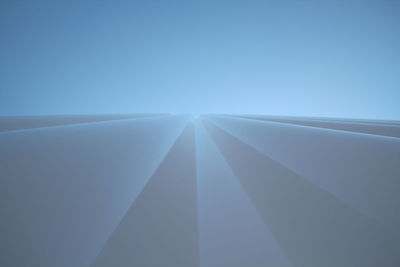 Close-up of airplane wing against clear sky