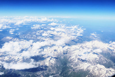 Aerial view of snowcapped mountain against sky