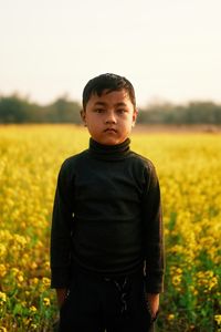 Portrait of boy standing on field