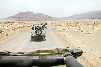 Jeep on road against sky