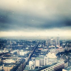 Cityscape against cloudy sky