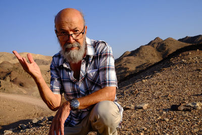 Senior bearded man looking away in the desert 