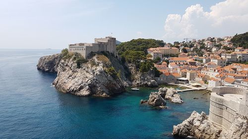 Panoramic view of sea and buildings against sky