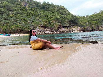 Full length of young woman on beach