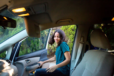 Tween girl enters the car to sit in the front seat