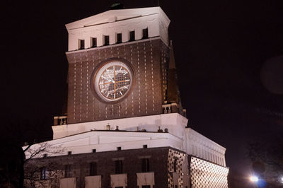 Low angle view of clock tower against clear sky