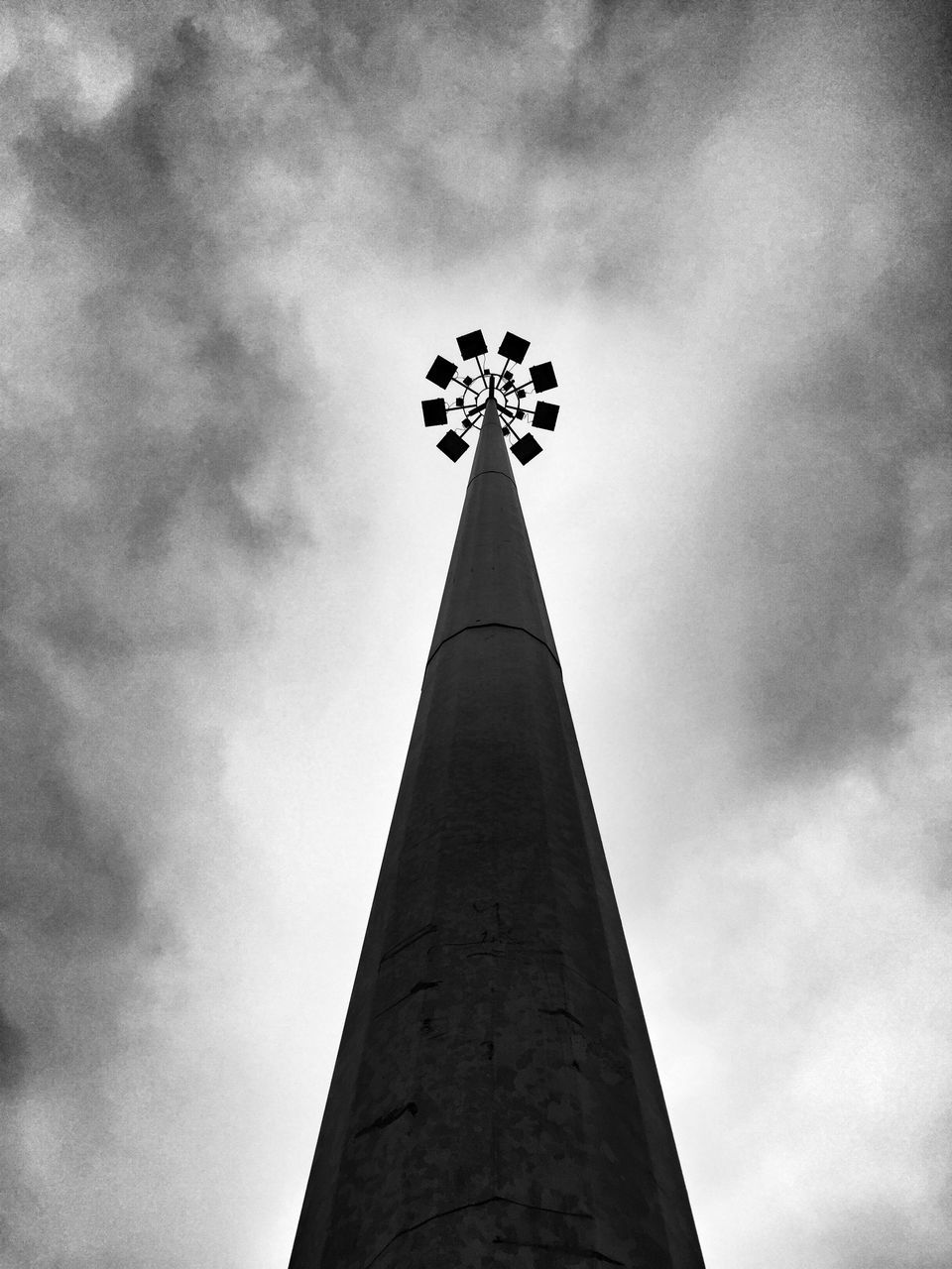 low angle view, sky, cloud - sky, built structure, cloudy, architecture, tall - high, religion, tower, cross, cloud, overcast, weather, no people, outdoors, day, tall, silhouette, travel destinations