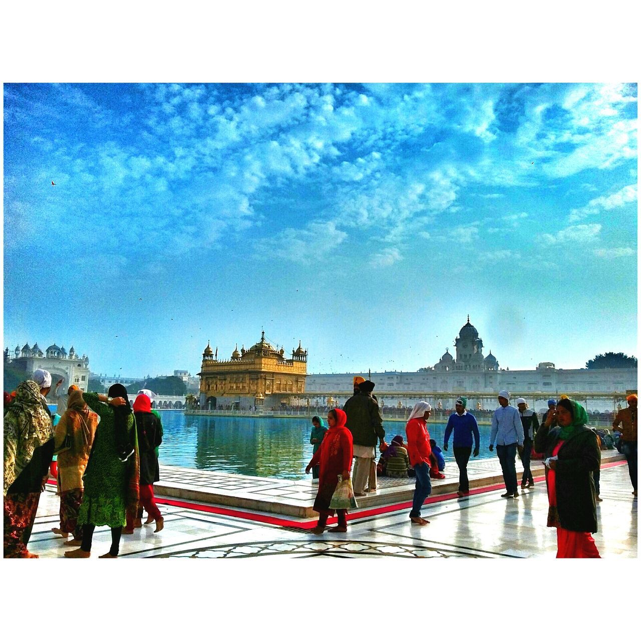 transfer print, lifestyles, sky, leisure activity, large group of people, men, person, water, auto post production filter, cloud - sky, togetherness, rear view, tourist, mixed age range, built structure, standing, architecture, vacations, full length