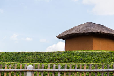 Built structure on field against sky