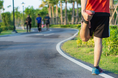 Rear view of man walking on road