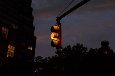 Low angle view of illuminated street light against sky at night