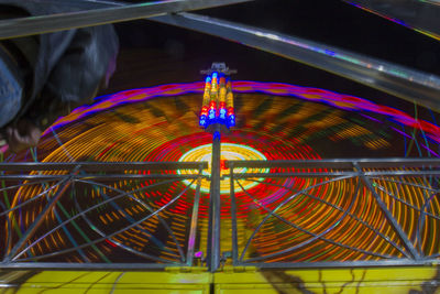 Low angle view of illuminated ferris wheel at night