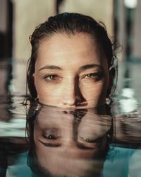 Portrait of young woman in swimming pool