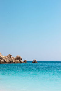 Scenic view of sea against clear blue sky