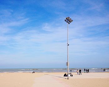 People on beach against sky