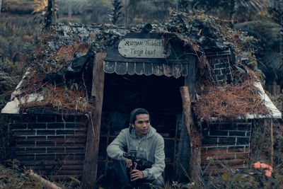 Portrait of young man sitting outdoors