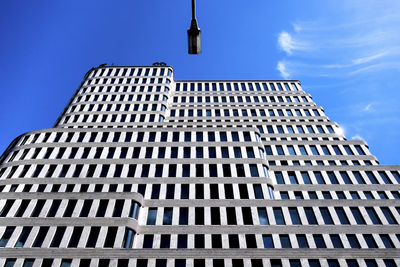 Low angle view of modern building against blue sky