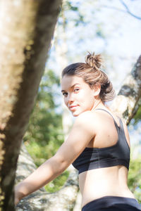 Portrait of teenage girl exercising in park