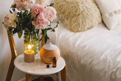 Aroma oil diffuser on chair against in the bedroom. air freshener.