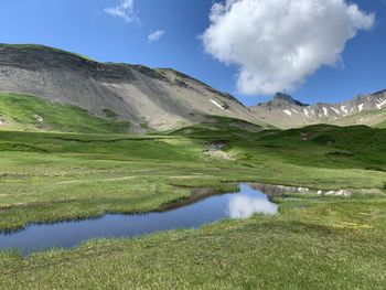 Scenic view of lake and mountains against sky