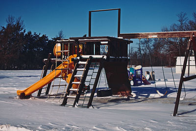 Built structure on field against clear sky during winter