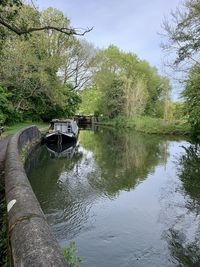 Boat moored in river against sky