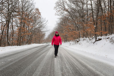 Rear view of woman on road during winter