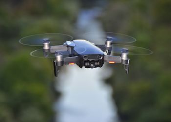 Close-up of drone flying over river