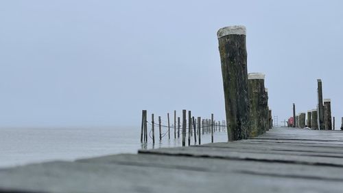 Pier over sea against clear sky