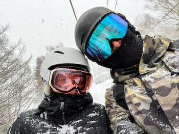 Selfie of a couple riding ski lift