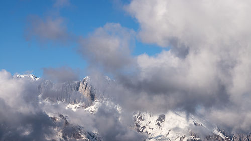 Low angle view of snowcapped mountain against sky