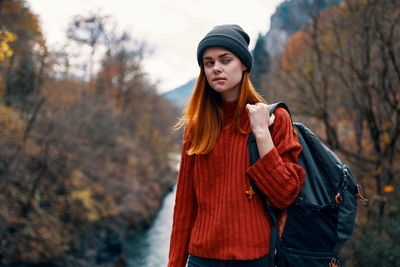 Young woman standing in park during autumn