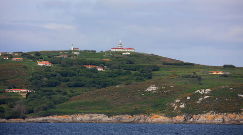 Scenic view of sea and mountains against sky