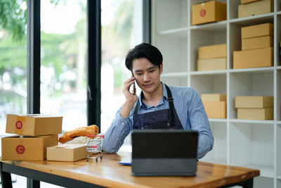 Young woman using laptop while sitting at home