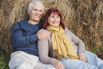 Portrait of happy friends sitting outdoors