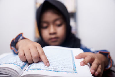 Portrait of boy holding book