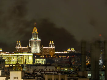 Distant view of illuminated moscow state university in city at night