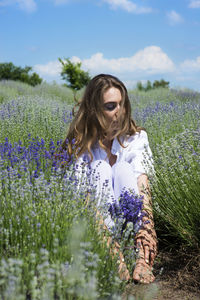 Woman seating in the middle of the lavender field