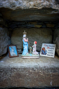 Rear view of man sitting on rock