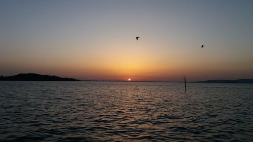 Scenic view of sea against sky during sunset
