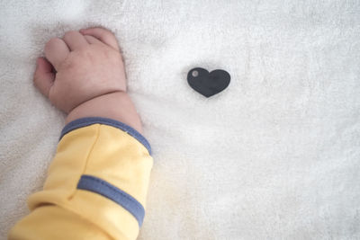 Close-up of baby lying on bed