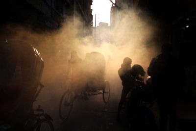 Rear view of people on street in city at night