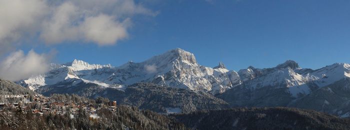 Scenic view of snowcapped mountains against sky